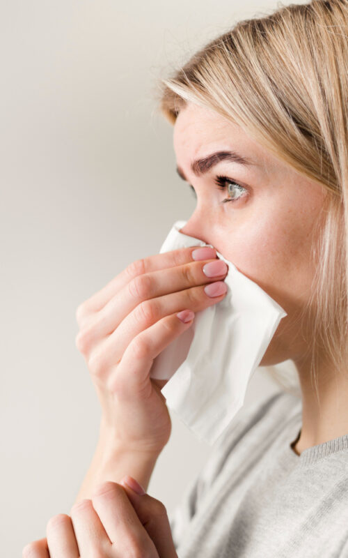 close-up-woman-blowing-nose